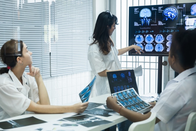 Radiology team analyzing brain MRI images to support accurate diagnosis and...