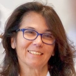 Smiling woman with dark hair - Prof. Minerva Becker...