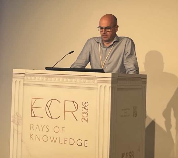 Man talking on a stage about disaster radiology: Dr. Niall Sheehy...