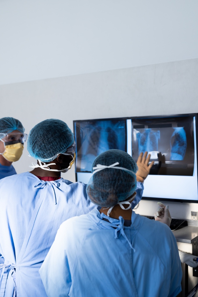 Group of medical professionales looking at a patients scan....