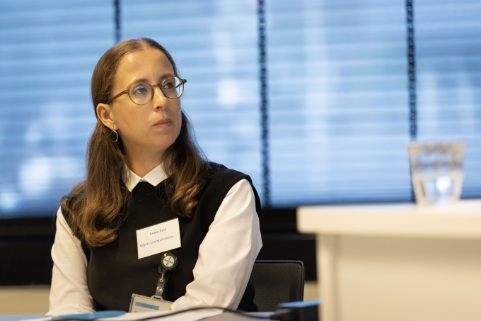 Woman sitting and watching something off screen