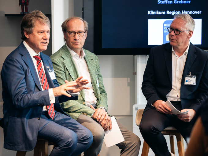 Dr. Jeffrey Cleveland, Steffen Grebner and Dr. Markus Vogel on stage in...